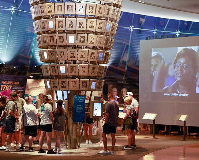 people in a museum looking at images