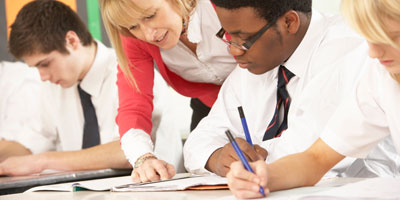 Private school teacher helping student