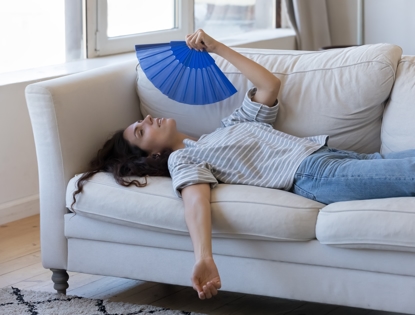 woman on couch with fan