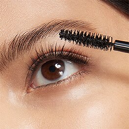 photo of woman showing how to apply mascara