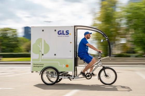 GLS van driving past a field of tulips