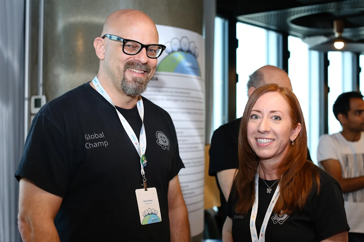 A man and a women wearing lanyards.