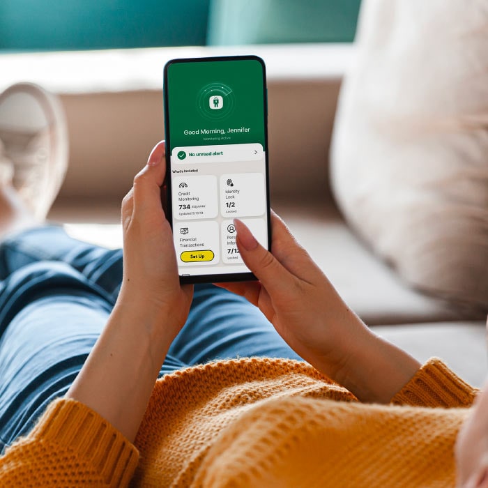 A woman checks an identity theft alert in the LifeLock app. 