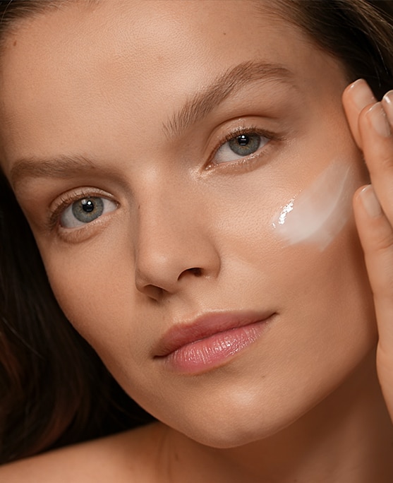 photo of woman applying skincare