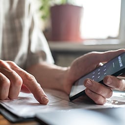 User search for password in notebook while holding their mobile phone