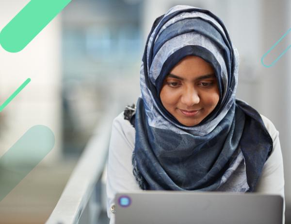 A woman looking down at her laptop