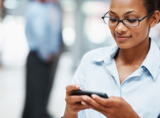 woman using a mobile device to access social media