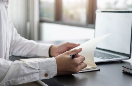 Man looking at letter.