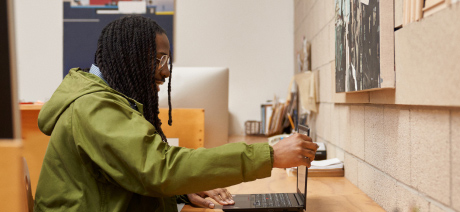 A seated professional opens a laptop