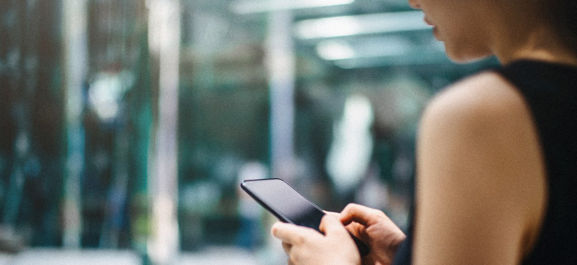 Photgraph of person looking at phone