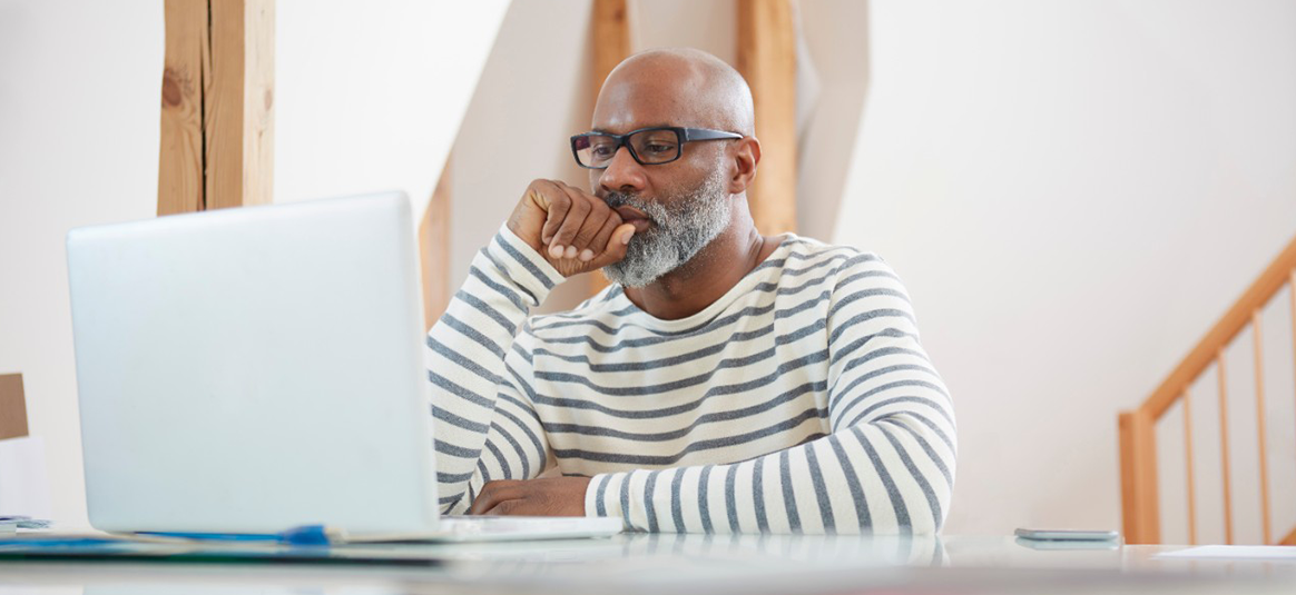 Photo of a person working at a laptop computer