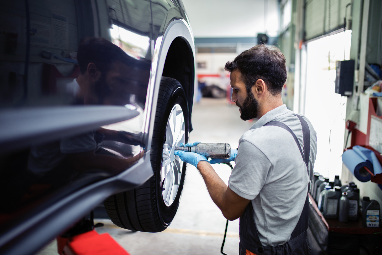 auto mechanic changing tire at repair shop