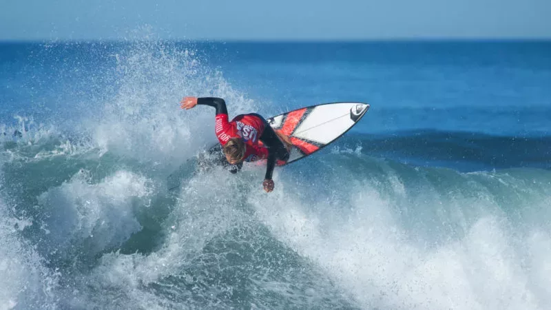 Surfer riding wave on short board