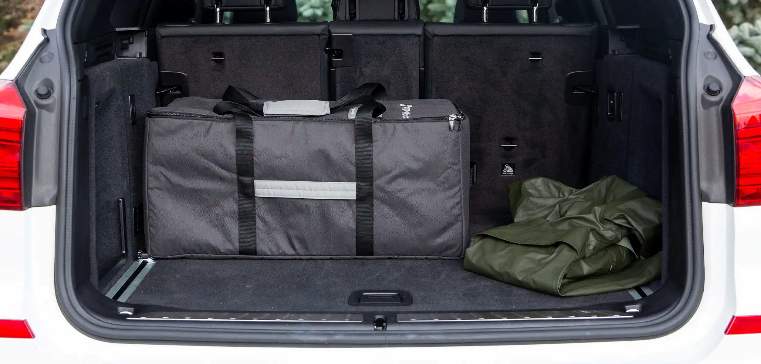 A Remi playard folded in the included storage bag easily fits in a car trunk for on- the-go use