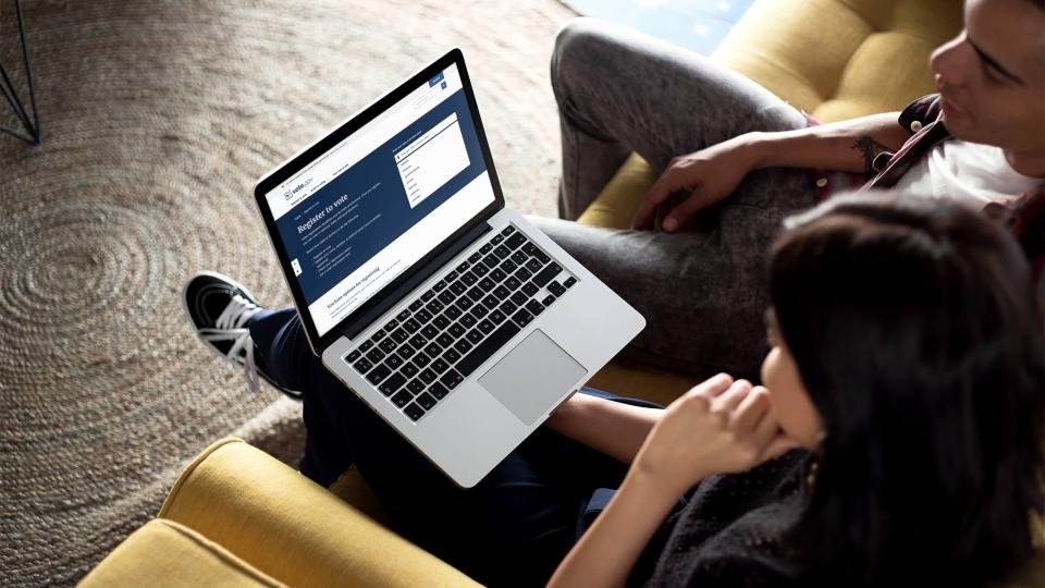 Young person looks at vote.gov site on a laptop.