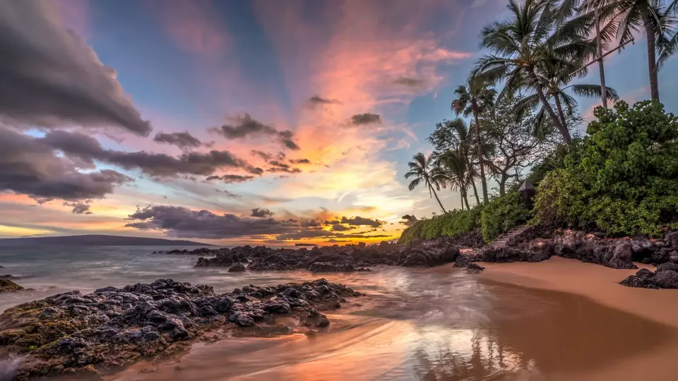 Hawaii volcanic rock and beach line at late sunset