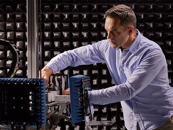 An Apple Hardware employee working on machinery in a silicon lab.