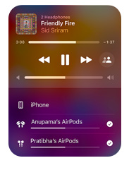 Apple Music interface on iPhone that shows two pairs of AirPods listening to the same song from one device, both sets of AirPods have individual volume settings.