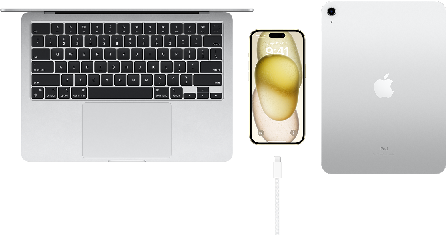 Top view of MacBook Pro, Phone 15 with a USB-C connector, and iPad