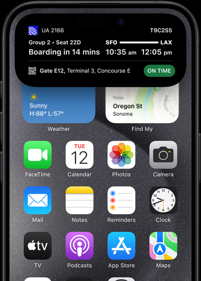 iPhone 15 Pro with Dynamic Island showing live sports scores