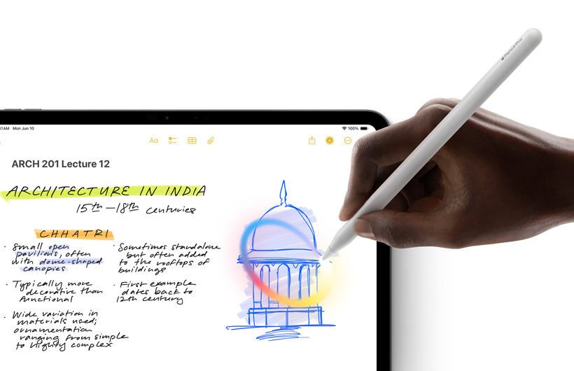 A hand holding Apple Pencil draws a circle around a sketch in the Notes app on iPad.