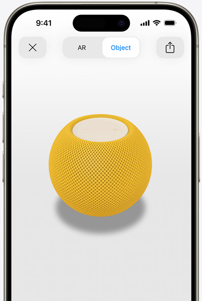 HomePod jaune en réalité augmentée sur l’écran d’un iPhone.