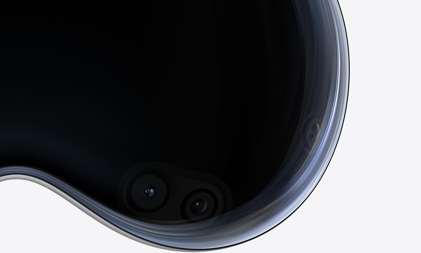 Apple Vision Pro 正面近距离特写，展示弧形玻璃罩后面的摄像头和传感器。