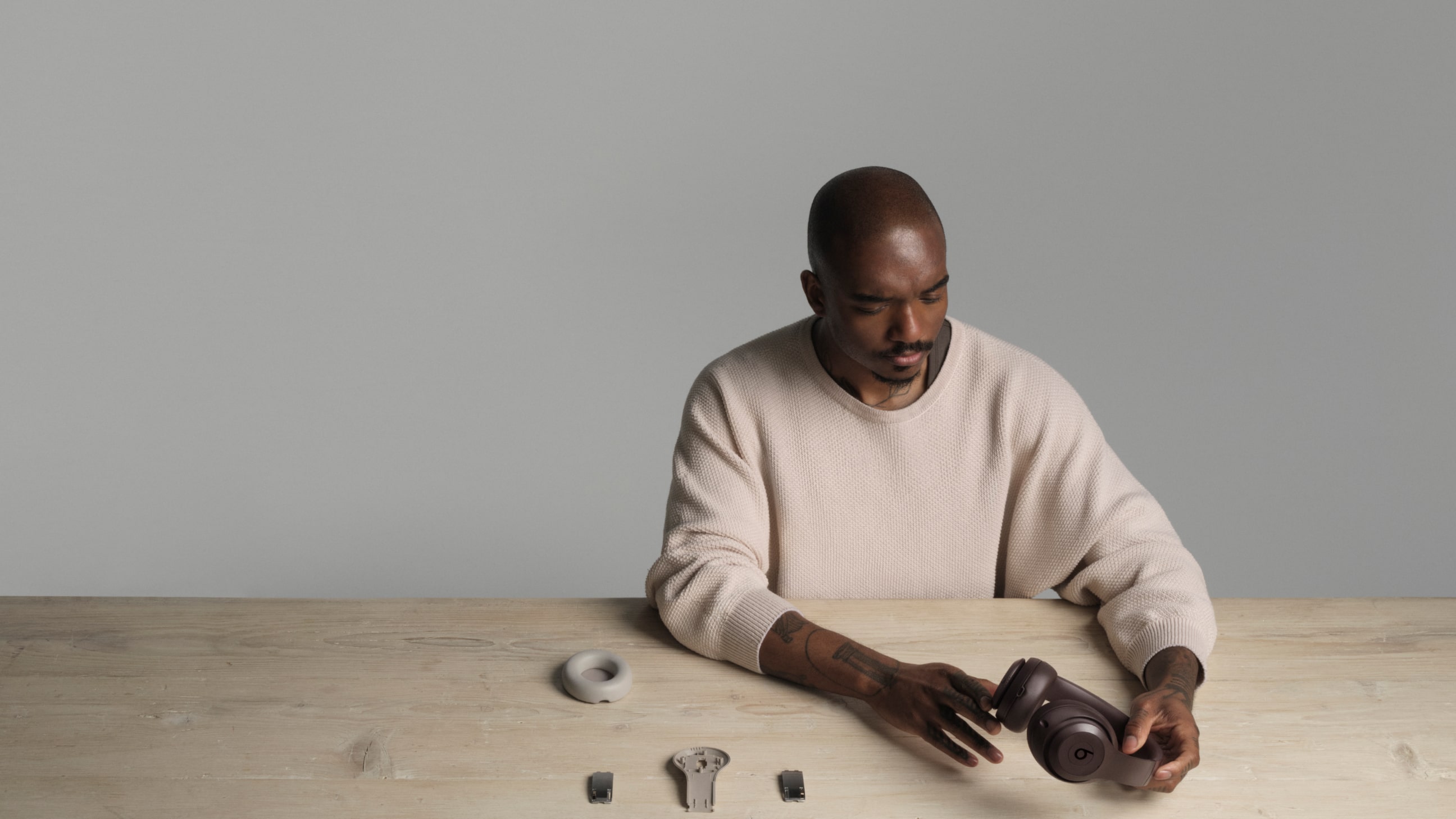 Samuel Ross holding Beats Studio Pro Wireless Headphones in the colour Deep Brown