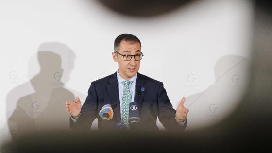 Bundesminister Cem Özdemir steht bei der Pressekonferenz zur G7-Agrarministerkonferenz vor einer Wand mit G7-Logo - vor ihm Mikrofone.