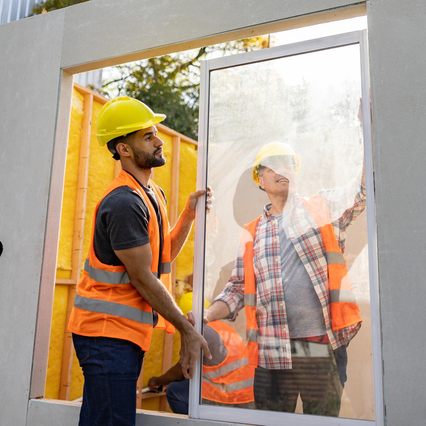 Kitemark - Latin American construction workers installing a window at a building