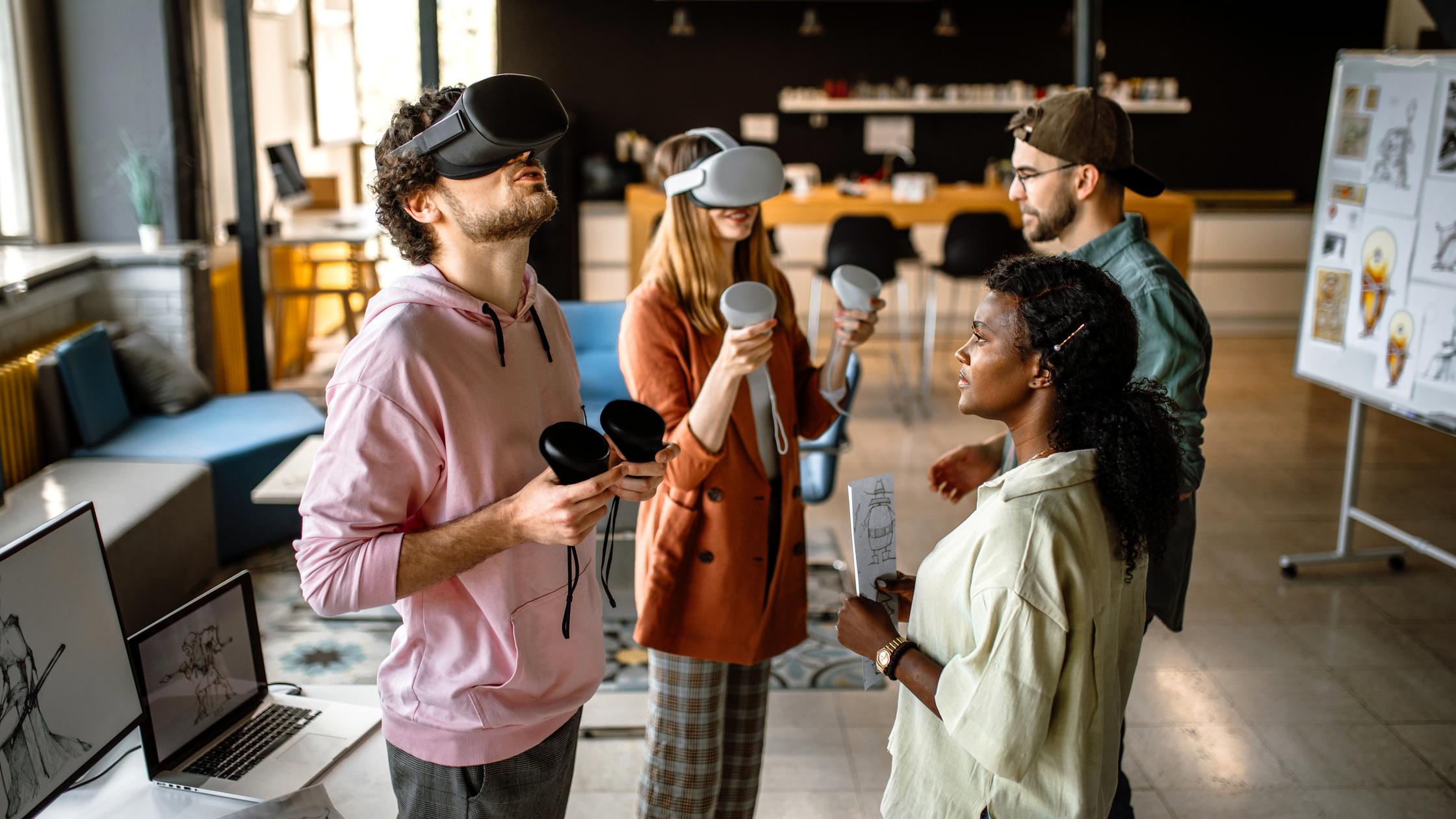 Innovation in ICT - Group of colleagues in company office using virtual reality simulator headsets