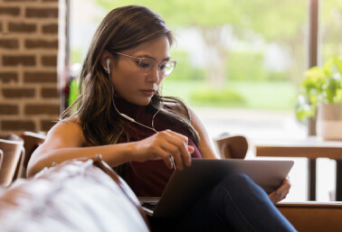 Woman with glasses using laptop