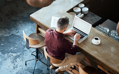 man at coffee shop on laptop