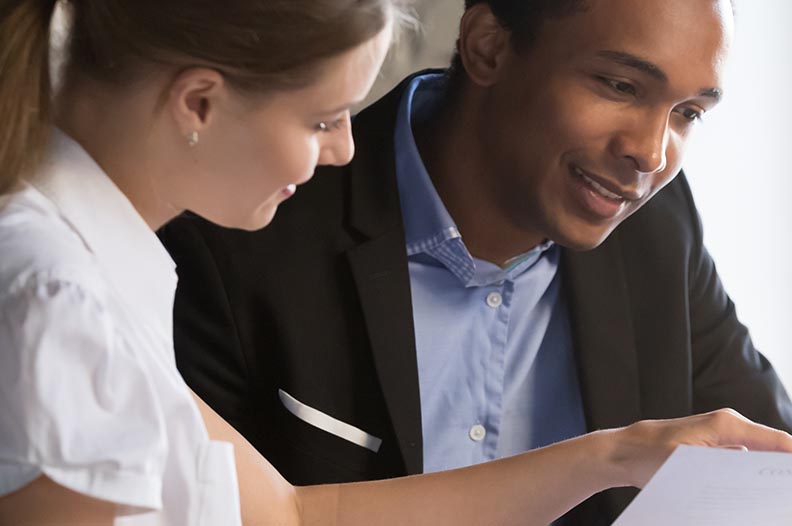 Photo of man and woman looking at documents