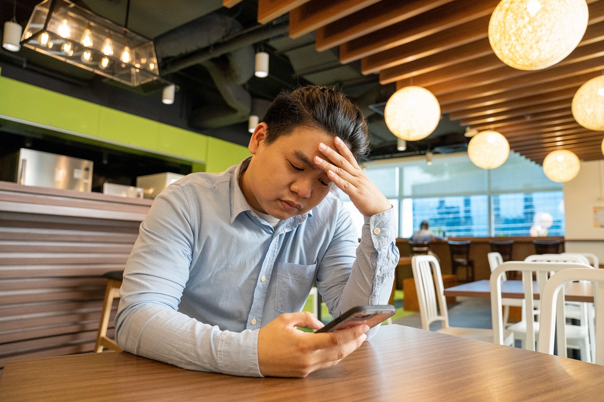 young man thinking about online shopping