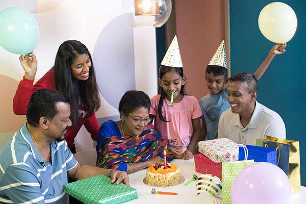 three generation family celebrating a birthday together