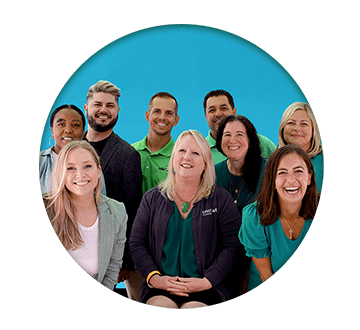 Circle group photo of Cricket Employees on a blue background