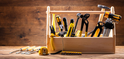 wooden toolbox filled with various tools