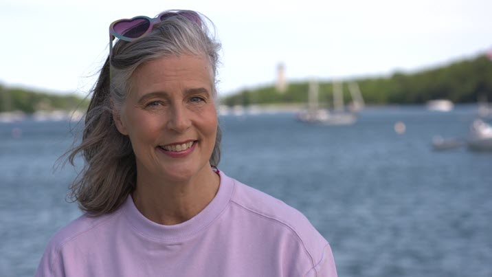 Nancy Regan smiling with the ocean in the background.