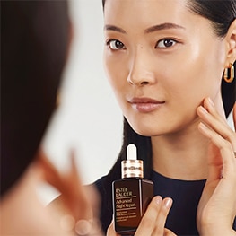 photo of woman applying estee lauder advanced night repair serum for sleep deprived skin