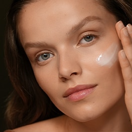 photo of woman applying skincare