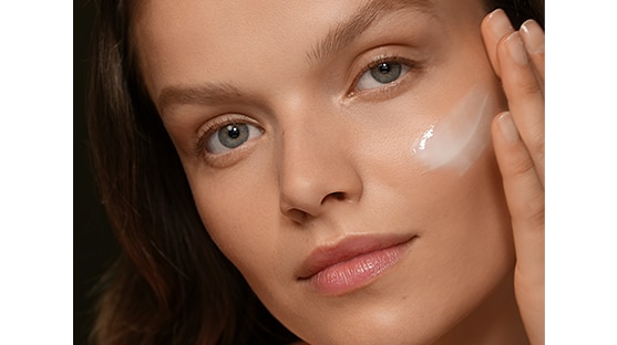 photo of woman applying skincare