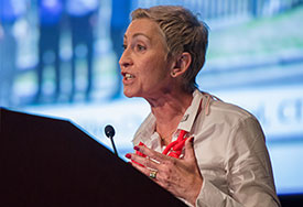 Linda-Gail Bekker speaks at a podium