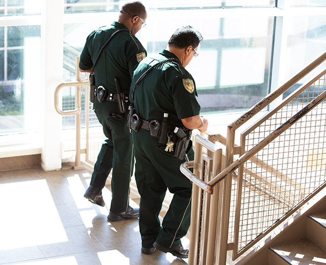 Officers walking down stairs in large building