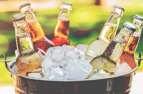 An ice bucket containing six bottles of drinks