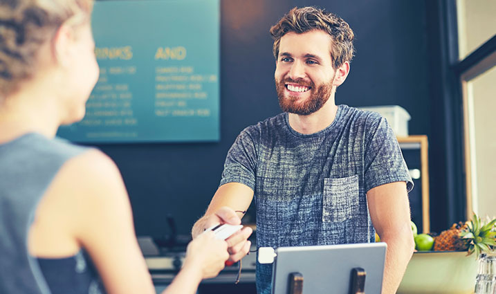 Cashier handing over item to a customer