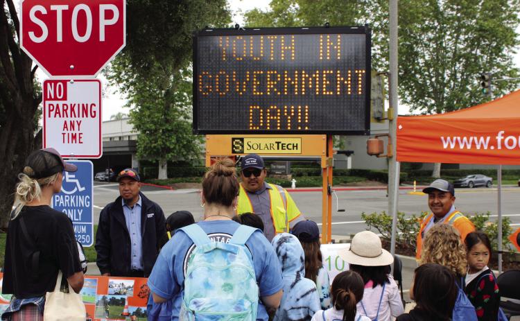 Sign maker Timmy Hoang (l), arborist Irving Castillo (c) and irrigation technician Jeronimo Cheluca (r) talk with students about the work that keeps our city such a nice place to live. PHOTOS BY SCOTT ROGERS / FOUNTAIN VALLEY LIVING