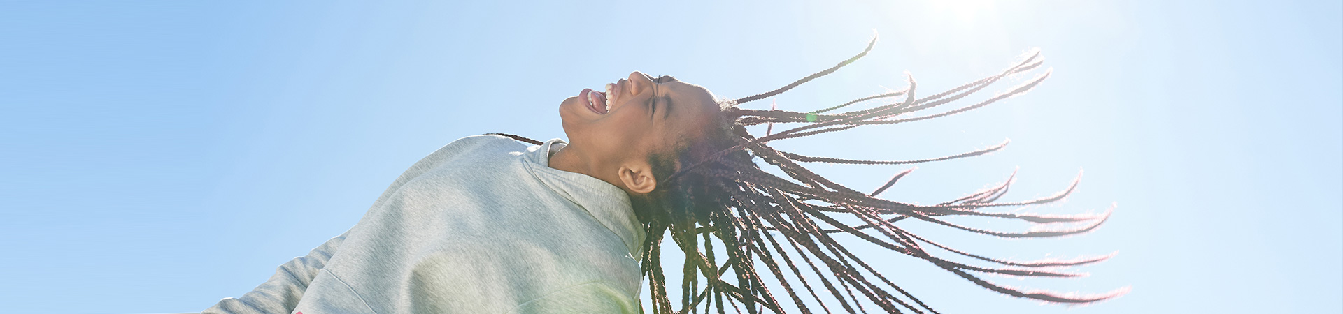  Portrait of a girl flinging her hair back in the sunshine 