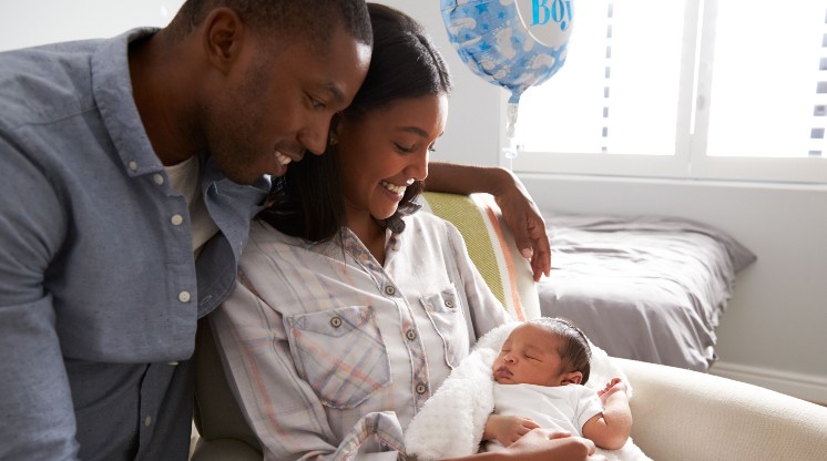 parents holding baby