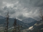 A helicopter buckets water onto smouldering fires outside Jasper, Alberta, Canada, on Friday July 26, 2024. AMBER BRACKEN/Pool via REUTERS(via REUTERS)